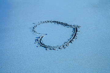 inscription heart on beach sand, blue toned