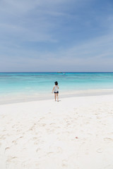 Outdoor summer portrait of young pretty woman sunbathing on the beach, enjoy her freedom and fresh air.
