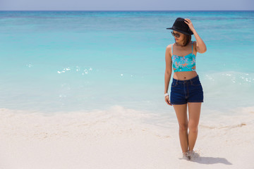 Outdoor summer portrait of young pretty woman sunbathing on the beach, enjoy her freedom and fresh air.