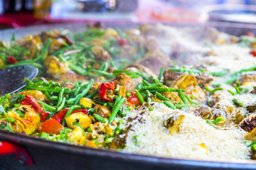 Steaming hot paella, seafood, rice and vegetables in French mark