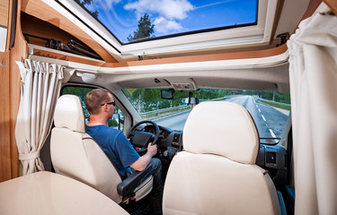 Man driving on a road in the Camper Van