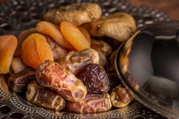 Fototapeta na wymiar Ramadan Dates and Dried Fruits Iftar Plate with cover