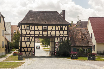 Building over the road in rural Germany village. Old house as ex