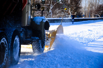 Snow plow truck workiyng in a city park