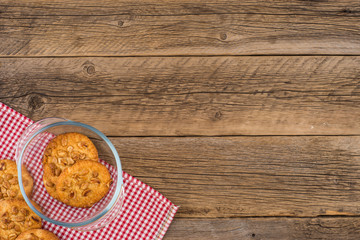 Peanut cookies in a glass bowl on old wooden table.