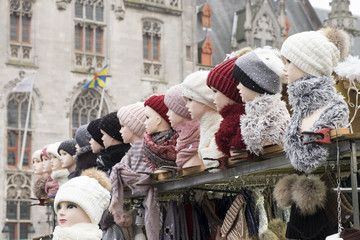 Fototapeta na wymiar A row of hats on a Christmas market stall in the Belgian city of Bruges