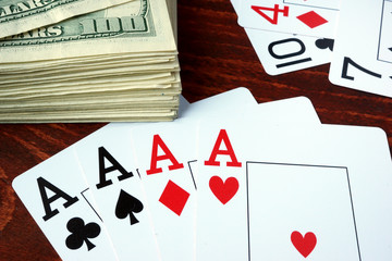 Four aces and dollar banknotes. Gambling concept.