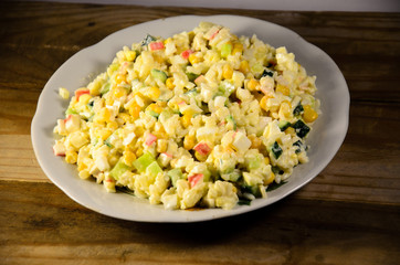 Salad with crab sticks, corn, cucumber, and eggs