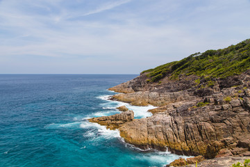beautiful view, waves crashing into the rocks and mountain