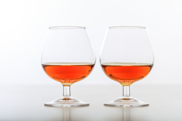 Two cognac glasses on white background