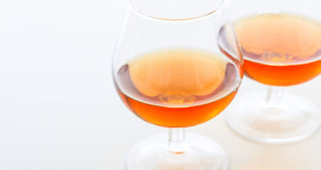 Two cognac glasses on white background