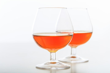 Two cognac glasses on white background