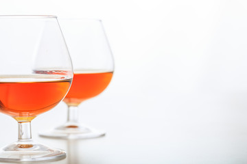 Two cognac glasses on white background