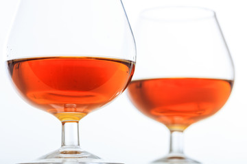 Two cognac glasses on white background