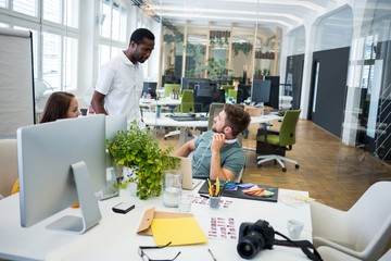 Graphic designers interacting at their desk