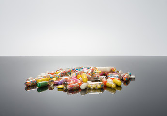 Pills on a black glossy background