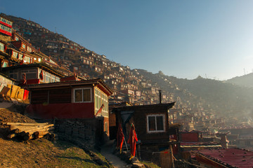 Top view monastery at Larung gar (Buddhist Academy) in a warm and foggy morning time, Sichuan, China