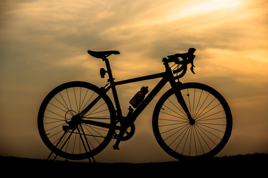Silhouette Bicycle with beautiful landscape at sunset