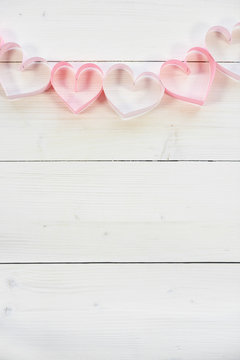Hearts shape made by pink paper .