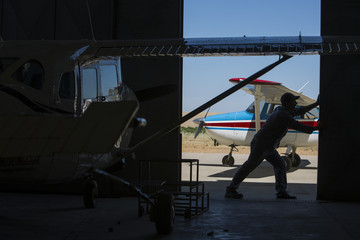 Mechanic opening hangar gate