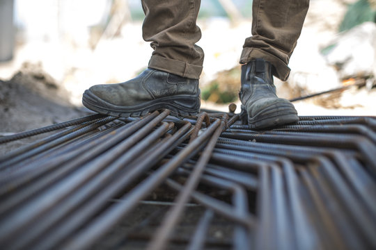 Construction worker standing on steel beams