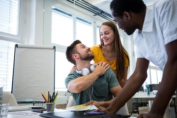 Graphic designers interacting in the office