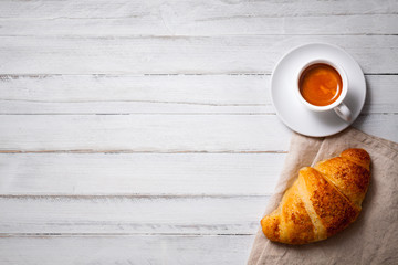 cup of espresso coffee with croissant on white wooden table, empty space on left - 132223305