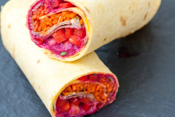Various of tasty tortilla wraps on a wooden background. Healthy street food