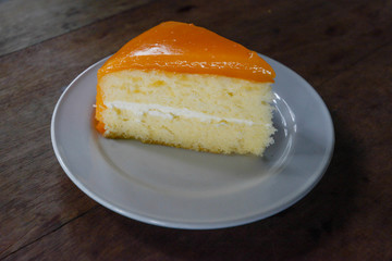 Orange cake on wooden background