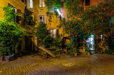 Night view of old cozy courtyard in Rome, Italy