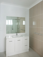Fototapeta na wymiar New compact ensuite bathroom with ensuite, shower and tiled wall