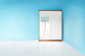 white and wood wardrobe in blue wall empty bedroom