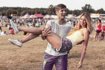 Man holding girlfriend during festival