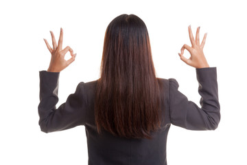 Back view of Asian business woman show double OK hand sign.