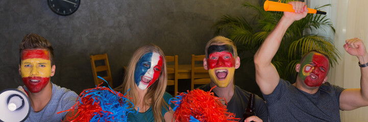 International fans with pompoms and painted faces