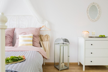 Bed, dresser and decorative lantern - obrazy, fototapety, plakaty