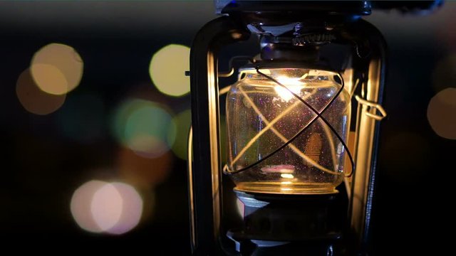 Paraffine Kerosene lantern on a background of defocused colored lights.