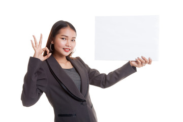 Young Asian business woman show OK with  white blank sign.