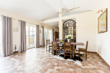 Spacious dining room with rustic tiles