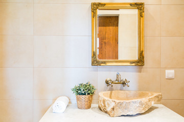 Fototapeta na wymiar Stone sink and mirror in bathroom