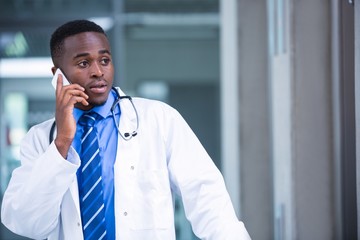 Tensed doctor talking on mobile phone
