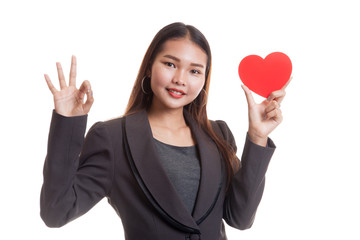 Asian business woman show OK with red heart.