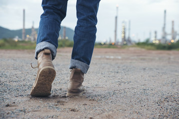Closeup of leg of engineers or safety officer ,wearing blue jeans. safety brown shoes ,standing in...