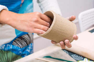 Women Hand Making a Jar of Raw Clay. Professional Handmade Workshop Studio Closeup