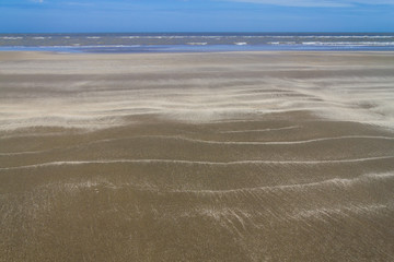 Dry over wet sand  and waves in Cassino beach