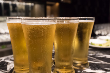 Glass of beer served on the counter in a party