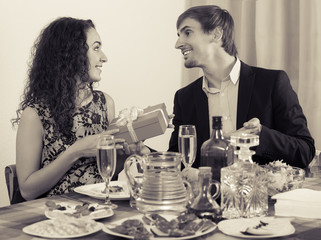 Young man giving present to beautiful woman