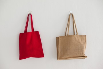 Red and beige fabric bags hanging on wall