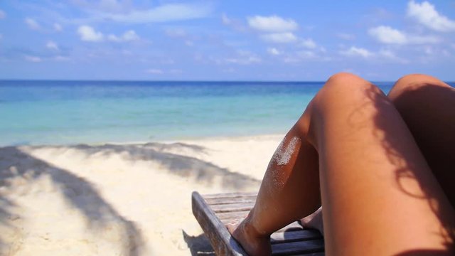 Woman Legs Sunbathing on Beach Enjoying Sea