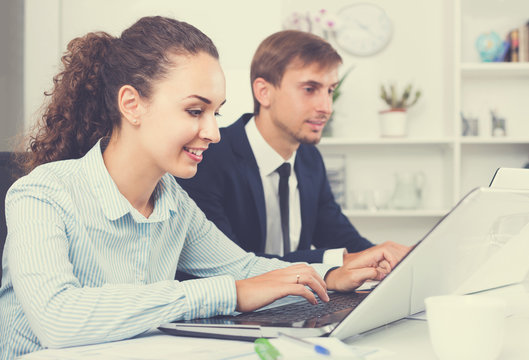 Portrait Of  Business Woman Sitting With Laptop On Desk In Offic